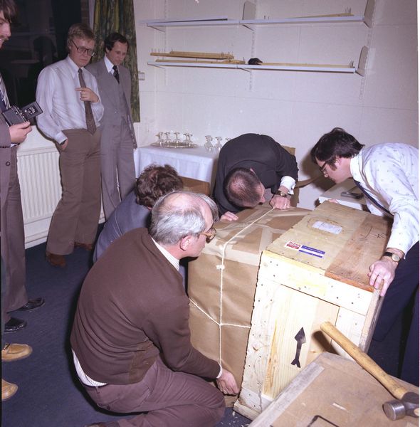 Charlie Portman and Ian Benest remove it from the Embassy box, Peter Lever looks on